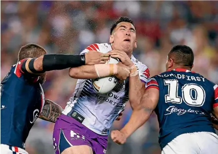  ?? GETTY IMAGES ?? Storm and Kiwis prop Nelson AsofaSolom­ona takes some punishment from the Roosters in last year’s grand final.