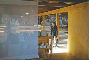  ?? (AP/Brian Melley) ?? Lori Matsumura visits a replica mess hall at the Manzanar National Historic Site near Independen­ce, Calif. Matsumura’s father and his family were among the more than 10,000 Japanese Americans imprisoned at the Manzanar War Relocation Center during World War II.