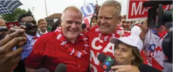 ?? MARK BLINCH/REUTERS FILE PHOTO ?? Then mayor Rob Ford with brother Doug enjoying Canada Day in East York in 2014.