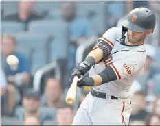  ?? TODD KIRKLAND — GETTY IMAGES ?? The Giants’ Tommy La Stella connects for a bases-empty home run in the first inning of Saturday’s 5-0 victory over the NL East-leading Atlanta Braves.