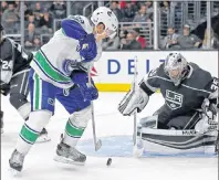  ?? AP PHOTO ?? Vancouver Canucks forward Bo Horvat and Los Angeles Kings goalie Darcy Kuemper battle in the third period of an NHL preseason game in Los Angeles on Saturday.