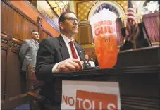  ?? Brian A. Pounds / Hearst Connecticu­t Media ?? Rep. Doug Dubitsky, R-Chaplin, protests Gov. Ned Lamont’s proposed highway tolls and tax on sugared drinks during the budget address to the general assembly at the Capitol in Hartford on Wednesday.