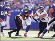  ?? Sarah Stier / Getty Images ?? The Giants’ Saquon Barkley runs the ball against the Falcons during a game last Sunday.