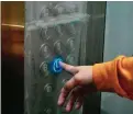  ??  ?? NEW STANDARD Elevator buttons are covered with plastic stickers for the safety of residents