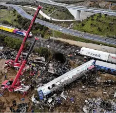  ?? VAGGELIS KOUSIORAS/AP ?? Firefighte­rs and rescuers supported by two cranes search through wreckage Thursday after trains collided in Tempe, about 235 miles north of Athens, Greece. It was the country’s deadliest rail crash on record.
