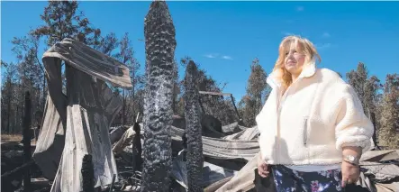  ?? Pictures: Nev Madsen ?? DEVASTATIO­N: Katherine Reeves among the remains of her Millmerran Downs home yesterday.