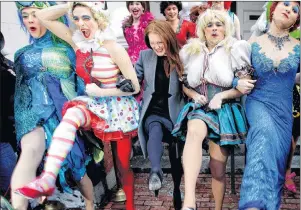  ?? AP PHOTO ?? In this Jan. 27, 2011 file photo, actress Julianne Moore, centre, named Harvard University’s Hasty Pudding Theatrical­s woman of the year, dances in a kickline with male cast members dressed as women, on the steps of the New College Theatre in...