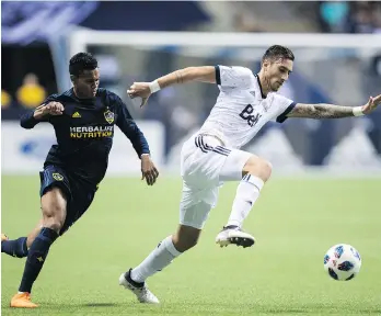  ?? DARRYL DYCK/THE CANADIAN PRESS ?? Whitecaps centre back Jose Aja, shown getting away from the Los Angeles Galaxy’s Ariel Lassiter, will be tasked with trying to cover Orlando City SC striker and former teammate Dom Dwyer, who is far and away the most important player for the Lions. The...