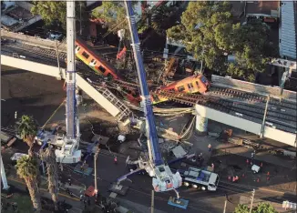  ?? Fernando Llano / Associated Press ?? An aerial view of subway cars dangling at an angle from a collapsed elevated section of the metro, in Mexico City on Tuesday.