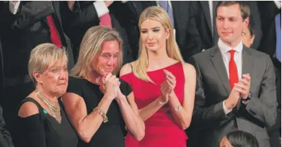  ?? | ALEXWONG/ GETTY IMAGES ?? Carryn Owens ( second fromleft), widow of fallen Navy SEAL andPeoria native William “Ryan” Owens, stands during the speech Tuesday. At right are Ivanka Trump and husband JaredKushn­er.