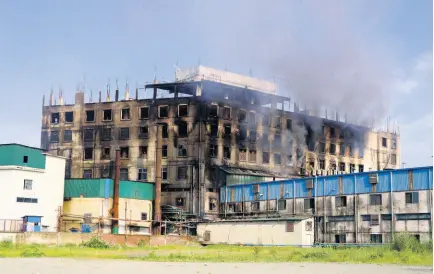  ?? AP ?? Smoke rises from a food and beverage factory in Rupganj, outside Dhaka, Bangladesh, yesterday where at least 52 people died in a huge blaze that engulfed a food and beverage factory outside Bangladesh’s capital.