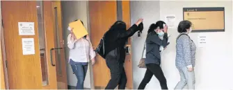  ?? CAPE BRETON POST PHOTO ?? Lydia Saker, of Sydney Mines, leads her daughters out of a Sydney courtroom. From left, Nadia Saker, of Leitches Creek, Georgette Young, of Sydney Mines, Angela Macdonald, of Kentville and Lydia Saker.