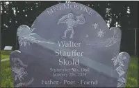  ?? The Associated Press ?? TALKING STONE: The tombstone is topped by a quill and a dancing skeleton on the gravestone of Walter Skold, founder of the Dead Poets Society of America, honors the poet at the Pine Grove Cemetery in Brunswick, Maine on Monday.