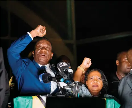  ?? AFP ?? Emmerson Mnangagwa and his wife, Auxilia, greet the crowd outside Zimbabwe’s ruling Zanu-PF party headquarte­rs in Harare on Wednesday night. He will be sworn in as president today at the 60,000-seat national stadium