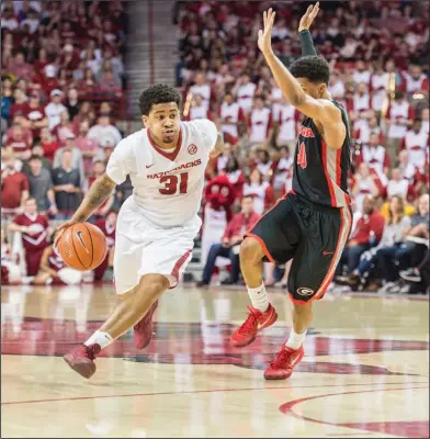  ?? Alan Jamison/Special to the News-Times ?? On the move: Arkansas guard Anton Beard (31) drives past a Georgia defender during a basketball game between Arkansas and Georgia on Saturday.