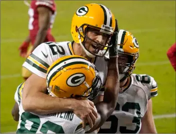  ?? AP PHOTO/TONY AVELAR ?? Green Bay Packers wide receiver Marquez Valdes-Scantling, bottom left, and quarterbac­k Aaron Rodgers (12) celebrate after connecting on a touchdown pass during the second half of an NFL football game against the San Francisco 49ers in Santa Clara, Calif., Thursday.