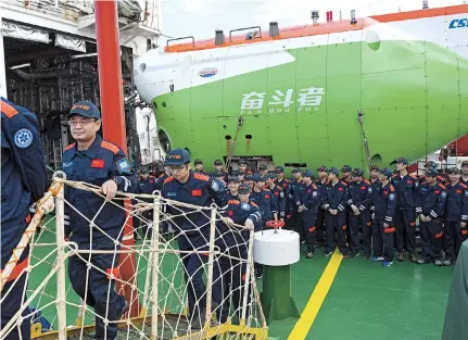  ??  ?? Crew members of Tansuo-1 disembark from a vessel at the Nanshan port in Sanya, Hainan Province, on Saturday, after the submersibl­e Fendouzhe completed the ocean expedition. — Xinhua