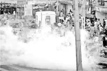  ?? — Reuters photo ?? A tear gas canister is fired to disperse Sudanese demonstrat­ors, during anti-government protests in the outskirts of Khartoum, Sudan.