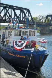  ?? RECORD FILE PHOTO ?? A couple of event-goers enjoying sitting on the Spirit of Albany at the 17th annual Tugboat Roundup in Waterford.