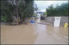  ?? ASSOCIATED PRESS FILES ?? A driveway is flooded, earlier this month, by the overflowin­g San Ysidro creek in Montecito. California Gov. Gavin Newsom has proposed cutting $40 million from the state budget for floodplain projects to help balance the state budget.