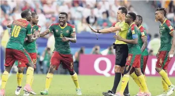  ?? AP ?? Cameroon players protest a red card by referee Wilmar Roldan during the Confederat­ions Cup Group B football match between Germany and Cameroon at the Fisht Stadium in Sochi, Russia, yesterday.