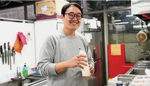  ??  ?? Where they cook: Kim Taehyung, owner of Seoul Poke, prepares food in the shared kitchen space at Simple Kitchen. — The Korea Herald