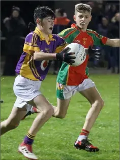  ??  ?? Aaron Bergin of Wexford C.B.S. on the move away from Ryan Donohoe.