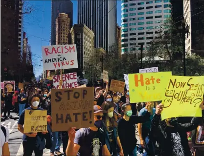  ?? PHOTOS BY DAI SUGANO — STAFF PHOTOGRAPH­ER ?? Hundreds of people march in San Francisco on Friday to protest recent attacks against Asian Americans.