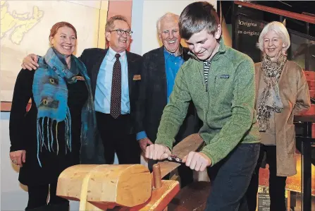  ?? CLIFFORD SKARSTEDT EXAMINER ?? Canadian Canoe Museum executive director CarolynHys­lop, left, and capital campaign chairman Bill Morris with directors Camilla and Peter Dalglish of the Dalglish Family Foundation watch their grandson Luke Abell, 15, carve a wood paddle on Tuesday.