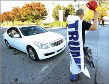  ?? Associated Press ?? ■ Christan Cooper, left, takes a picture of President Donald Trump supporter Bob Morris as he walks to a Trump campaign rally Sunday in Chattanoog­a, Tenn.