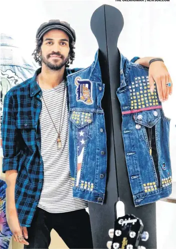  ??  ?? Artist Tony Thunder poses for a photo with some of his jean jacket artwork that is on display for the second annual Jean Genie Jean Jacket Art Show at the Paseo Plunge.