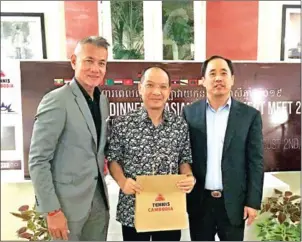  ?? TENNIS CAMBODIA ?? (Left to right) Tennis Cambodia secretary-general Tep Rithivit, Lao Tennis Federation secretary-general Sisomphet Xayarath and Tennis Cambodia president Oknha Sear Rithy receive gifts during the welcome dinner on Friday at the Palace Gate Hotel & Resort in Phnom Penh.