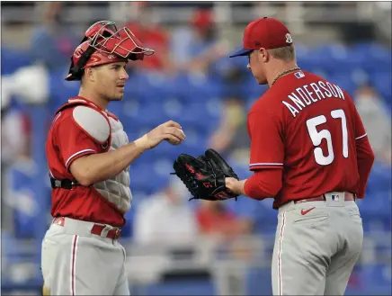  ?? STEVE NESIUS - THE CANADIAN PRESS FOR AP ?? The return of catcher J.T. Realmuto, left, and the addition of starting pitcher Chase Anderson, right, are among the reasons the Phillies enter the 2021 season with high hopes.