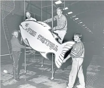  ??  ?? Aberdeen Fish Curers’ and Merchants’ Associatio­n director George Cumming, Alan Ritchie and sons Russell and Paul lend a hand with the preparatio­ns for the 1987 fish festival.