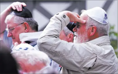  ?? Jens Meyer ?? The Associated Press People of different faiths wear the Jewish kippa during a demonstrat­ion against anti-semitism on Wednesday in Erfurt, Germany.