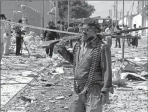  ?? AP/FARAH ABDI WARSAMEH ?? A Somali soldier patrols the area of a suicide car-bomb attack in Mogadishu, Somalia, in January.