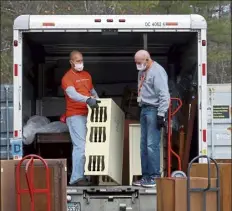  ?? JULIA MALAKIE / LOWELL SUN ?? Volunteers Robert Ashworth of Littleton, left, and Ralph Farnham of wayland load a truck for a delivery.
