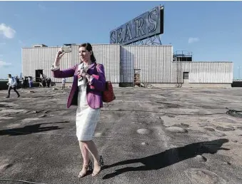  ?? Steve Gonzales / Houston Chronicle ?? Rice University’s announceme­nt to revamp the Sears building in Midtown into a high-tech site — and maintain some of its features — was attended by reporters including Courtney Fisher of KTRK-TV.