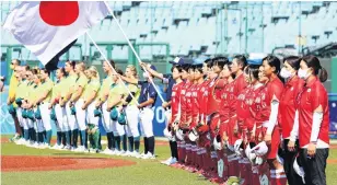  ?? PHOTO: GETTY IMAGES ?? Ready for action . . . Women’s softball teams from Japan and Australia parade in front of empty stands at the Fukushima Azuma Baseball Stadium before the opening game of the 2020 Olympics yesterday. Japan won 81.