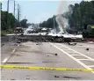  ?? AP PHOTO ?? FATAL SCENE: Charred debris covers a Georgia highway after yesterday’s crash of an Air National Guard C-130 cargo plane.