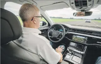  ?? PHOTOS: AUDI ?? Graeme Fletcher behind the wheel of Audi’s A8 with Level 3 autonomous driving capabiliti­es. If the autonomous driver fails, the car has a three-stage interventi­on process to safely stop the car.