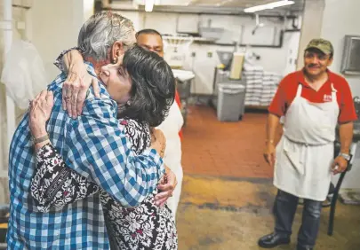  ?? Photos by Michael Ciaglo, Special to The Denver Post ?? Dino’s Italian Food owner Judy Duren hugs Lee Frey, a longtime friend of the restaurant, in the kitchen Friday in Lakewood. Duren just announced plans to close the 58-year-old restaurant in the coming weeks.