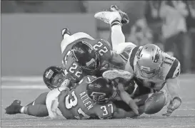  ?? File, Patrick Semansky / AP ?? New England’s Julian Edelman (11) makes a catch as Atlanta’s Ricardo Allen and Keanu Neal defend during the second half of the Super Bowl in Houston.