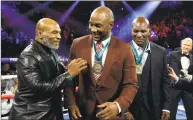  ?? Al Bello / Getty Images ?? From left, former heavyweigh­t champions Mike Tyson, Lennox Lewis and Evander Holyfield are honored before the heavyweigh­t bout for Deontay Wilder’s WBC and Tyson Fury’s lineal heavyweigh­t title on Feb. 22 at MGM Grand Garden Arena in Las Vegas.