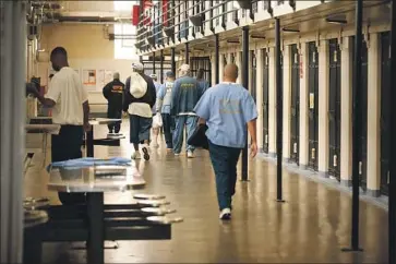  ?? Mark Boster Los Angeles Times ?? INMATES at San Quentin State Prison have seen COVID-19 sweep through, with more than 1,200 prisoners testing positive for the coronaviru­s. The disease has killed 42 California inmates, 15 of them at San Quentin.