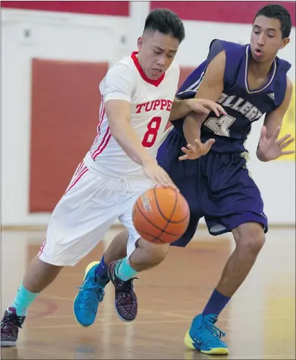  ?? GERRY KAHRMANN/PNG FILES ?? Charles Tupper's Ron Ronquillo, left, drives the ball past Vancouver College's Elijah Campbell-Axson during a December game. Ronquillo was the Triple A zone tournament MVP, while Campbell-Axson was named the 4A tournament MVP.