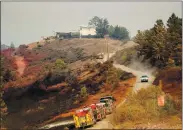  ?? RAY CHAVEZ — STAFF PHOTOGRAPH­ER ?? Firefighte­rs monitor the Walbridge Fire near Chemise Road in Healdsburg as the LNU Lightning Complex Fire continues burning regions of Napa and Solano counties on Sunday.