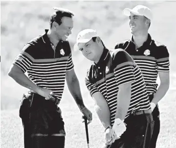  ?? AP ?? PRACTICE. Tiger Woods of the US places the cover of a water sprinkler on his head as he jokes with Patrick Reeds, center, and Jordan Spieth, right, during a practice round of the Ryder Cup at Le Golf National in Saint-Quentinen-Yvelines, outside Paris, France, Thursday, Sept. 27, 2018.