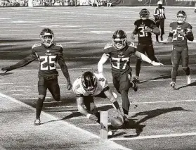  ?? Wesley Hitt / Getty Images ?? Baltimore’s Lamar Jackson (8) ran for 136 yards and a touchdown during his first career playoff victory in a wild-card game against Tennessee on Sunday.