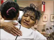  ?? ROD AYDELOTTE / WACO TRIBUNE-HERALD ?? Former Branch Davidian member Shelia Martin receives a hug after Thursday’s memorial service. Martin lost her husband and several children during the long siege in 1993.